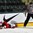 GRAND FORKS, NORTH DAKOTA - APRIL 24: Denmark's Magnus Molge #16 lays on the ice after a hit from Latvia's Erlends Klavins #18 resulting in a game misconduct penalty in the second period during relegation round action at the 2016 IIHF Ice Hockey U18 World Championship. (Photo by Matt Zambonin/HHOF-IIHF Images)

